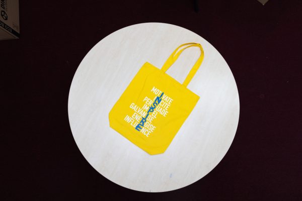 Yellow INSPIRE bags with blue and white printed letters